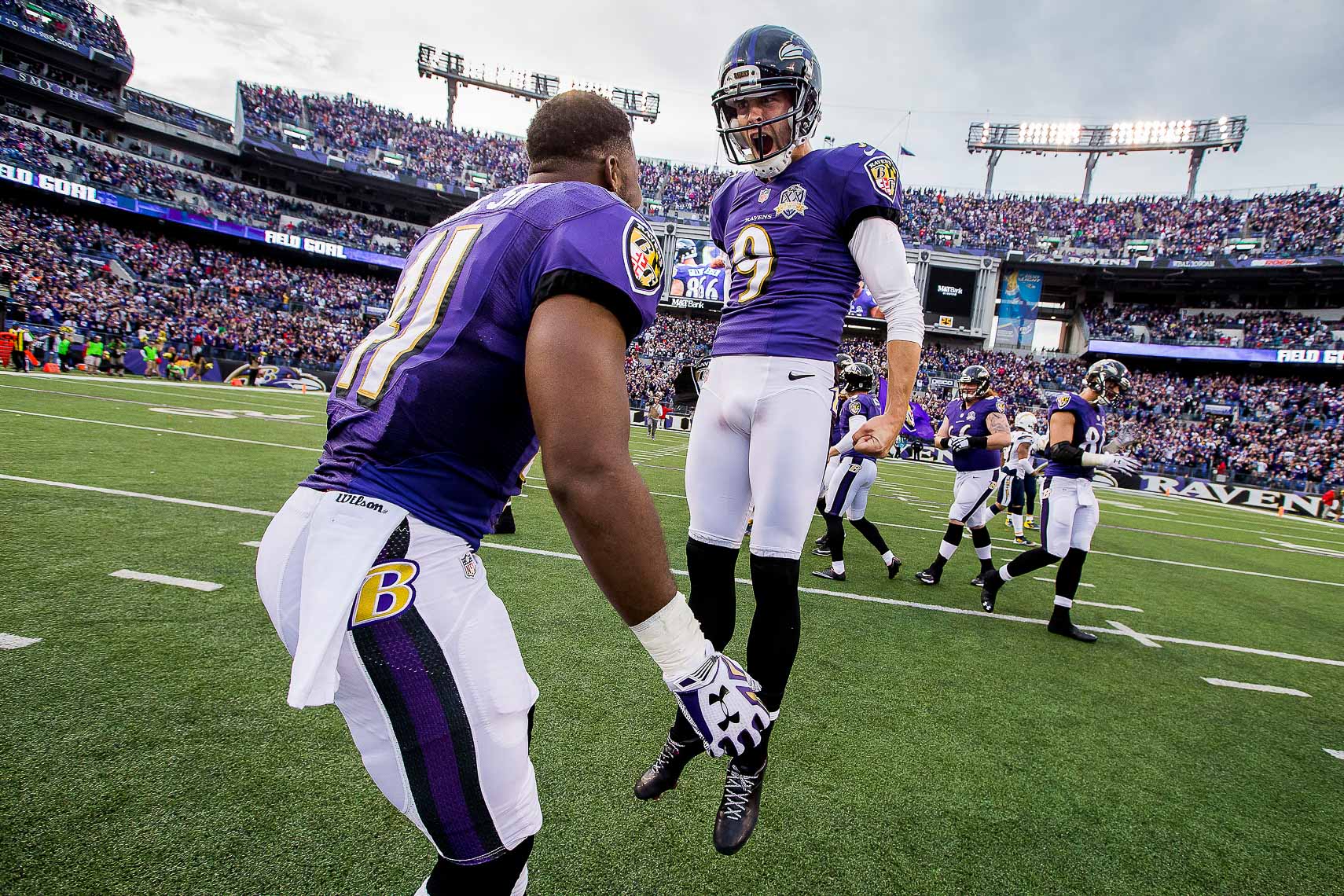 NFL football team Baltimore Ravens photographed in NIKE football uniforms by commercial advertising sports photographer in baltimore maryland showing sports action photography
