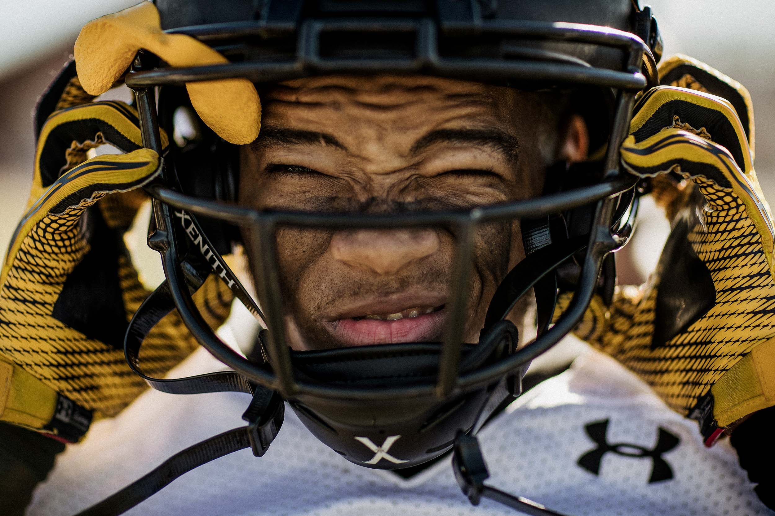 Maryland St. Frances Academy Panthers high school football athlete photographed my professional sports advertising photographer in baltimore maryland for documentary wearing an under armour football uniform