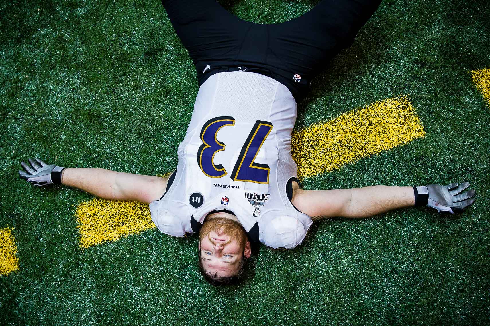 NFL football team Baltimore Ravens photographed in NIKE football uniforms by commercial advertising sports photographer in baltimore maryland showing sports action photography